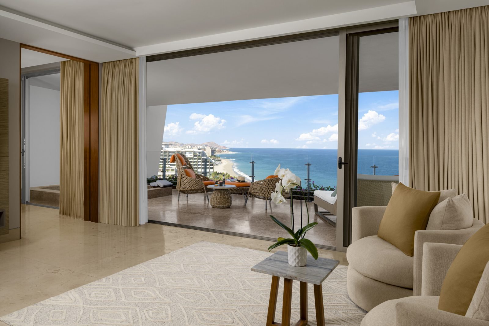Sala de una suite con ventanal al mar