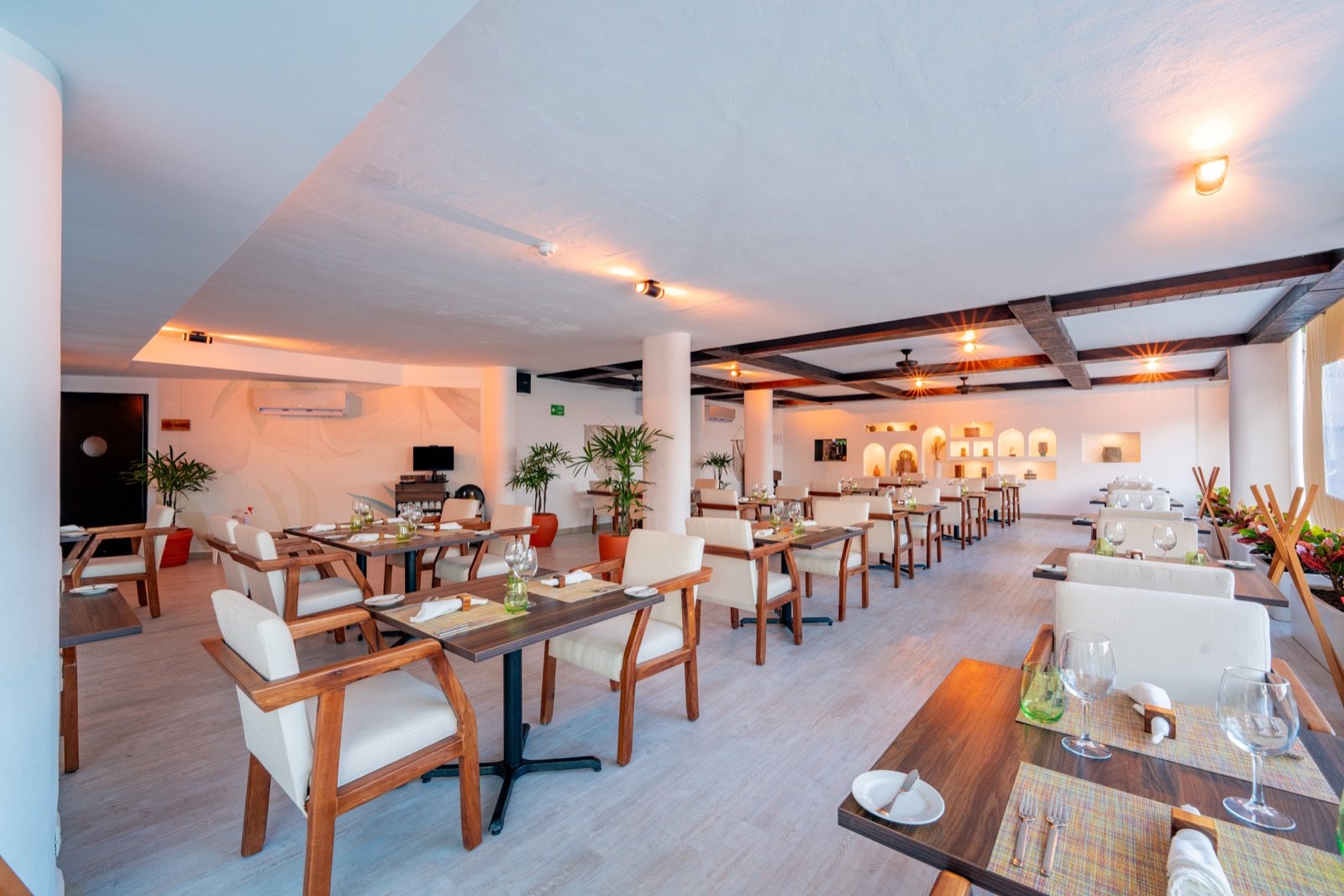 El comedor de Santa Sirena, con vigas de madera y mesas puestas